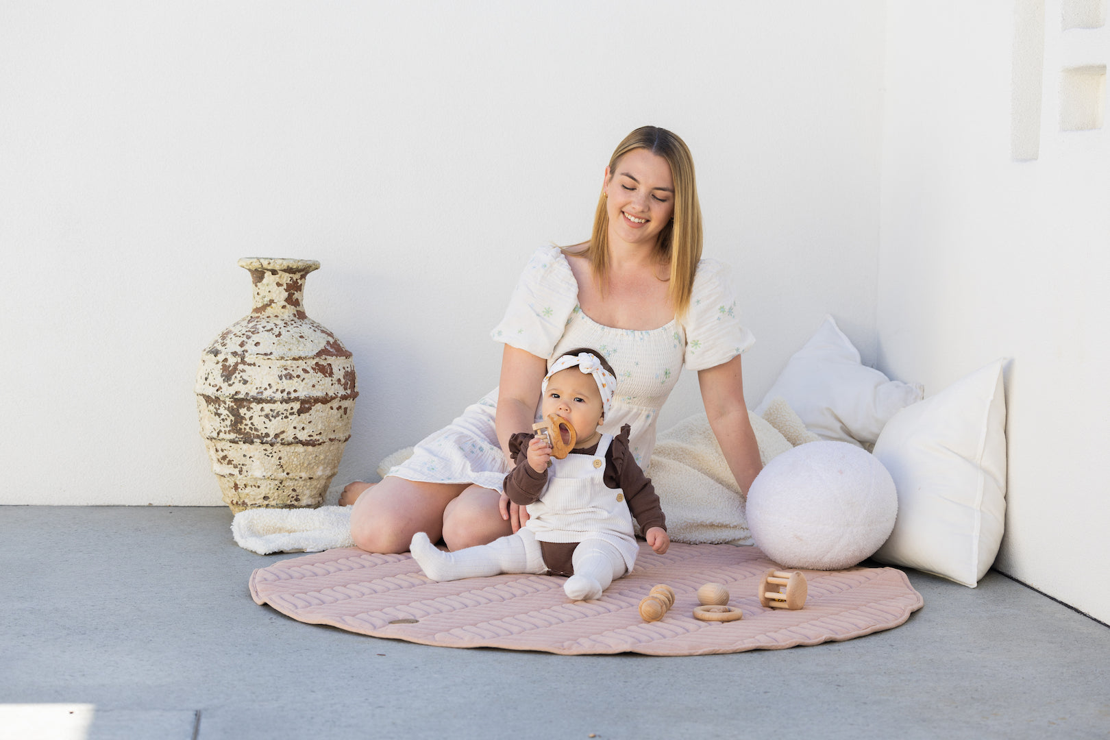 Pampas play mat with mother, newborn and toddler playing on the mat